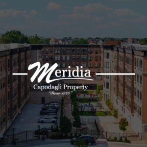 Meridia Capodagli Property project: Exterior view of a residential building with parking and courtyard, showcasing architectural design.