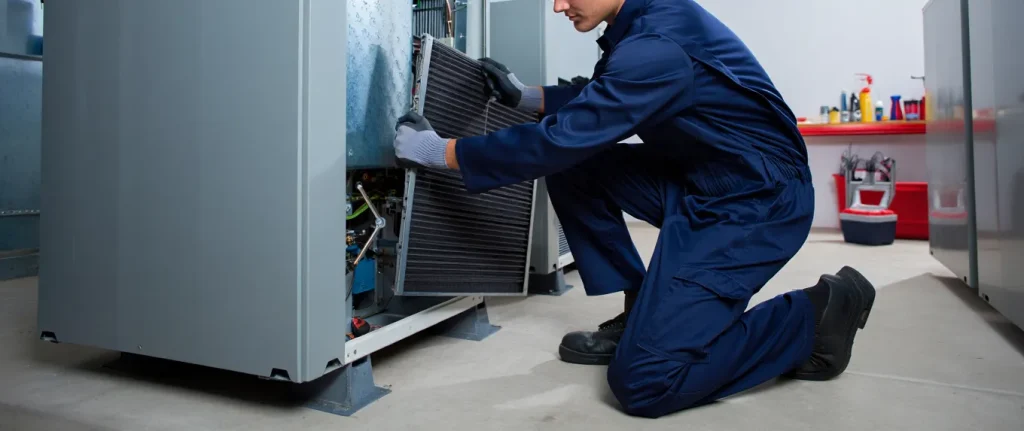 HVAC technician replacing a filter in Brooklyn, NY. Man in blue uniform performing HVAC maintenance. Air conditioning repair and service.