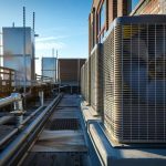 Commercial HVAC units on a rooftop with clear blue sky, emphasizing air conditioning maintenance for Brooklyn businesses.